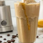 Protein Frappuccino: glass of a creamy Protein Frappuccino, with condensation dripping down the side