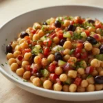 Dense Bean Salad: Hearty dense bean salad with chickpeas, beans, and fresh vegetables in a bowl