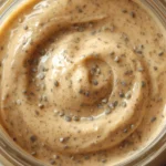 Keto Chia Seed Pudding Overnight: Thick creamy chia seed pudding in a glass jar topped with fresh raspberries.