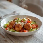 Greek Turkey Meatball Bowl: A vibrant Mediterranean bowl with golden turkey meatballs, ruby-red tomatoes, and glistening feta cheese on a fresh cucumber base.