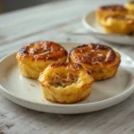 Keto Egg Muffins: Golden keto egg muffins with cheese and vegetables in a muffin tin, perfect for low carb breakfast.