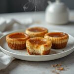 Cheesecake Bites Low Carb: Creamy no-bake cheesecake bites low carb snack with glistening almond flour crust on a white plate.