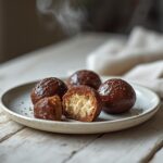 Chocolate Hazelnut Truffles Keto: Rich, creamy chocolate hazelnut truffles keto on a plate, with a glistening caramel-brown coating and toasted nut aroma.