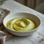 Creamy Avocado Cottage Bowl: Creamy avocado cottage bowl in a white dish with a smooth green texture and a golden olive oil sheen.