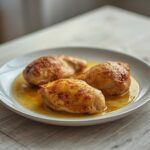 Garlic Butter Chicken Thighs: Golden crispy garlic butter chicken thighs in a skillet with a glossy amber sauce.
