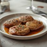 Herb Crusted Beef Medallions: Juicy Herb Crusted Beef Medallions with a golden, crispy herb crust on a plate.