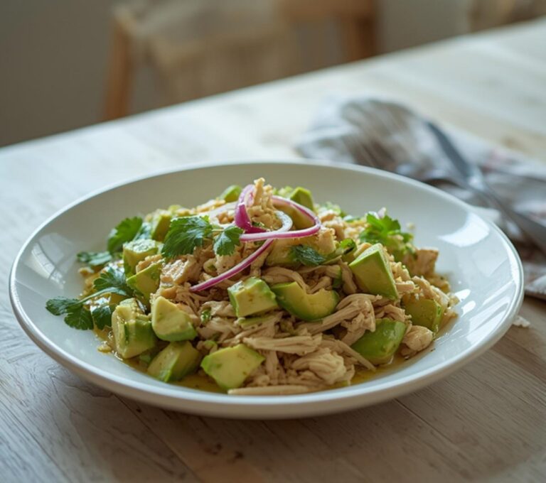 Home 11 Keto Avocado Chicken Salad: Keto Avocado Chicken Salad in a white bowl with creamy avocado, fresh cilantro, and shredded chicken.