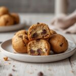 Keto Cookie Dough Bites: Keto cookie dough bites glistening on a tray with creamy texture and melted chocolate chips.