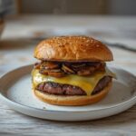 Keto Mushroom Swiss Burger: Juicy Keto Mushroom Swiss Burger with melted Swiss cheese and caramelized mushrooms on a low-carb bun.