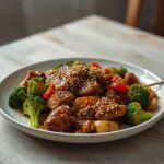 Keto Sesame Beef Stirfry: Keto Sesame Beef Stirfry in a wok with glistening steak, broccoli, and peppers.