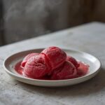 Keto Strawberry Sorbet: Creamy ruby-red keto strawberry sorbet in a bowl, a refreshing low-carb dessert.