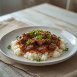 Korean Beef Bowl: Korean beef bowl with ground beef glazed in soy sauce over white rice, topped with green onions and sesame seeds.