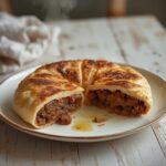 Lamb Kofta Stuffed Bread: Golden Lamb Kofta Stuffed Bread with glistening meat and fresh parsley on a rustic table.