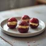 Lemon Cream Stuffed Berries: Ruby-red strawberries stuffed with creamy lemon filling on a keto snack board.