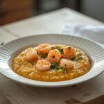 Lemon Garlic Shrimp Risotto: Creamy lemon garlic shrimp risotto in a skillet with glistening shrimp and fresh parsley garnish.