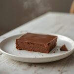 Low Carb Chocolate Fudge: Easy low carb chocolate fudge squares with a glistening, creamy texture on a rustic board.