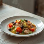Mediterranean Tuna Salad: Mediterranean Tuna Salad in a bowl with ruby-red tomatoes and glistening olive oil