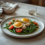 Niçoise Salad: Fresh Niçoise Salad with flaky tuna, golden eggs, and crisp greens on a rustic table.