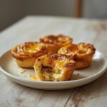 Sausage Cheese Egg Muffins: Golden baked Sausage Cheese Egg Muffins with melted cheese in a muffin tin, perfect for a keto breakfast.