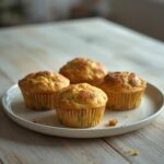 Savory Zucchini Muffins Keto: Golden savory zucchini muffins keto breakfast with green flecks on a plate.