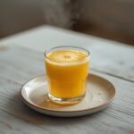 Wheatgrass Pineapple Shot: Glistening amber Wheatgrass Pineapple Shot in a small glass, fresh and vibrant.