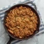 A rustic cast iron skillet filled with a freshly baked golden Keto Apple Crisp dessert