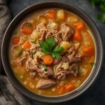 A warm bowl of creamy Leftover Turkey Soup Low Carb garnished with fresh parsley sprigs